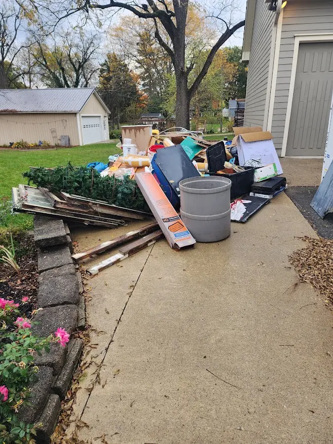 Dumpster being loaded with debris for 3 Yard Dumpster Rental in Gunbarrel